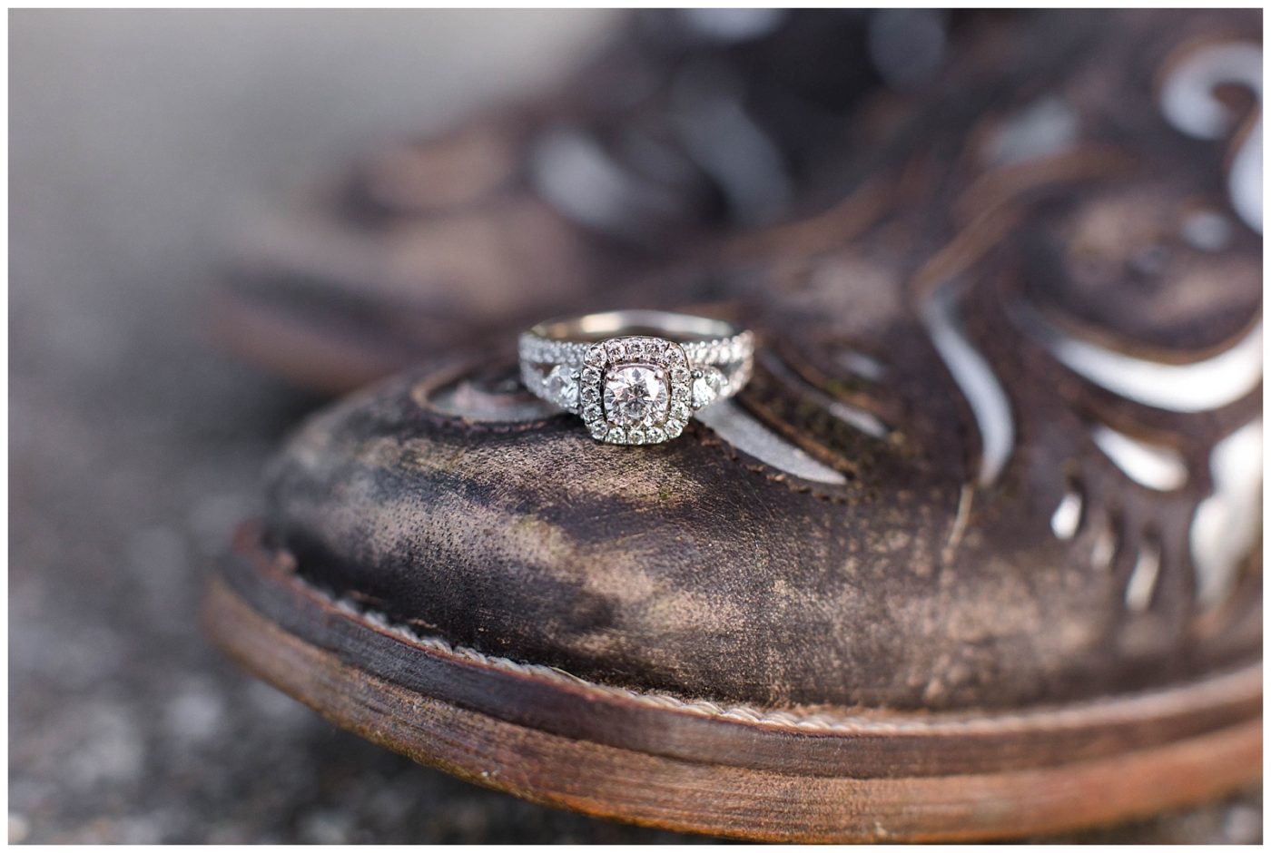 Engagement ring resting on a cowboy boot for an engagement session 